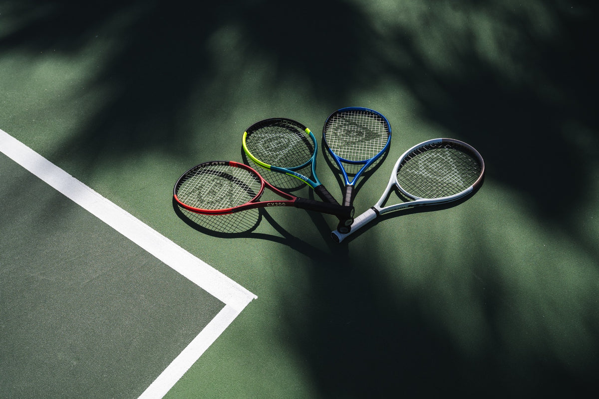 Dunlop tennis racquets arranged on a green court